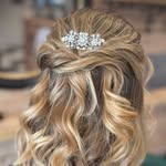 Curled occasion updo with jewelled hair accessory